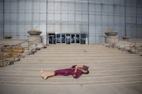 a woman laying on the steps of a building