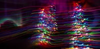 a long exposure image of a colorful christmas tree