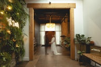 a bride and groom standing in an open doorway