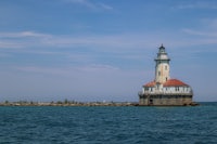 a lighthouse in the middle of a body of water