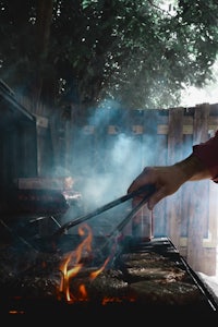 a person is grilling a steak on a grill