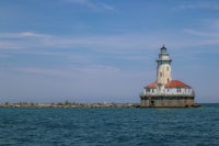 a lighthouse in the middle of a body of water