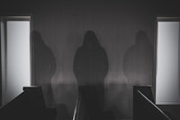 shadows of three people standing in a church