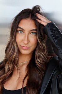 a woman with long hair posing for a photo