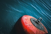 a red buoy floating in the water