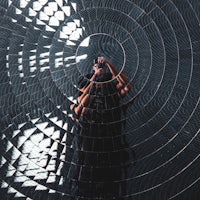 a person is standing in front of a circular mirror