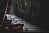 a black and white photo of a waterfall in a park