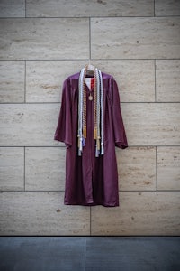 a graduation gown hanging on a wall