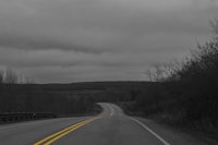 a black and white photo of an empty road