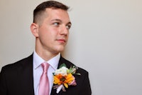 a man in a suit with a flower on his lapel