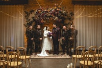 a bride and groom standing in front of a wedding ceremony